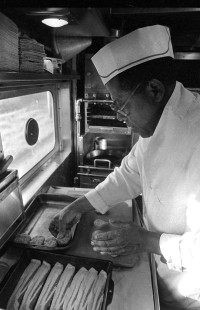 Leland "Sugar" Cain, chef of the Presidential Car, prepares breakfast for crew members before the Circus World Museum's circus train departs from Baraboo for Madison, Wisconsin, over the Chicago & North Western on May 19, 1981. Photograph by Henry A. Koshollek.