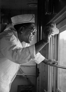 Leland "Sugar" Cain, chef of the Presidential Car, waves to onlookers as the circus train heads from Baraboo to Madison, Wisconsin, over the Chicago & North Western on the first leg of a trip to Milwaukee on May 19, 1981. Photograph by Henry A. Koshollek