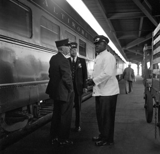 Crew members of a Baltimore & Ohio passenger train converse on the platform of Cincinnati Union Terminal in September of 1952. Photograph by Wallace Abbey. © 2016, Center for Railroad Photography and Art. Abbey-09-108-01