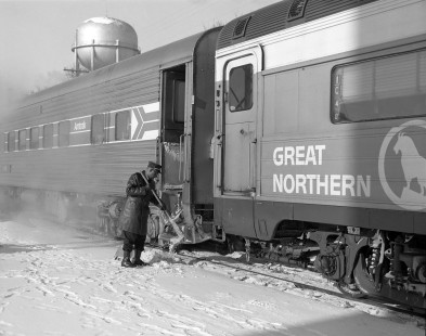 A porter prepares Amtrak's <i>North Coast Hiawatha</i> for riders, clearing snow from the steps of one of the passenger cars in Fargo, North Dakota, on December 8, 1972. Photograph by Victor Hand. Hand-AM-59-004