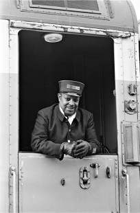 A sleeping car porter smiles for the camera on board the Burlington Northern Railroad's Seattle-bound <i>Empire Builder</i> passenger train during a station stop at Belton (West Glacier), Montana, on April 25, 1970. Photograph by Wallace Abbey. © 2016, Center for Railroad Photography and Art, Abbey-07-087-14
