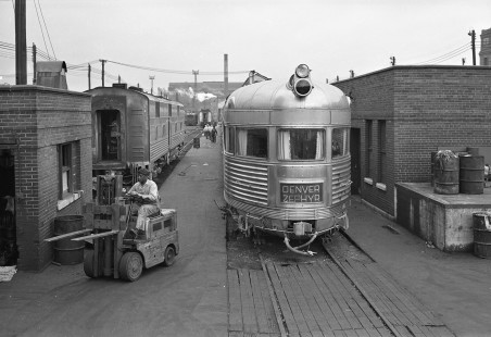A worker drives a fork lift past the observation car for the Chicago, Burlington & Quincy Railroad's <i>Denver Zephyr</i> passenger train at Fourteenth Street in Chicago Illinois, on June 3, 1951. Photograph by Wallace Abbey. Abbey-01-141-02; © 2015, Center for Railroad Photography and Art