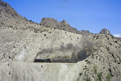 Turkish State Railways steam locomotive 56705 pulls the Kurtalan-Ankara mail train west through the rugged landscape near Çiftehan, Turkey, on September 13, 1973. Photograph by Victor Hand, collection of the Center for Railroad Photography & Art, Hand-TCDD-C25-03