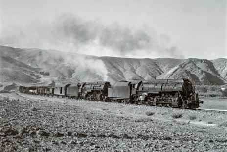 Two Turkish State Railways "Skyliner" locomotives lead a freight train south on the Zonguldak Line near Irmak, Turkey, on September 7, 1973. The Vulcan Foundry of Wilkes-Barre, Pennsylvania, built 88 of the 2-10-0 Skyliners for the Turkish Railways from 1947 to 1949. They were among the largest steam locomotives in Turkey, and the among the largest locomotives Vulcan ever built. Photograph by Victor Hand, collection of the Center for Railroad Photography & Art, Hand-TCDD-25-004