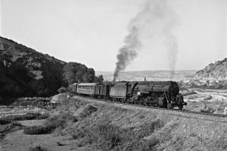 Turkish State Railways steam locomotive 56388 leads a freight train south on the Zonguldak Line near Eskipazar, Turkey, on September 8, 1973. Smoke from pusher locomotive 56332 is visible in the distance. Photograph by Victor Hand, collection of the Center for Railroad Photography & Art, Hand-TCDD-25-020