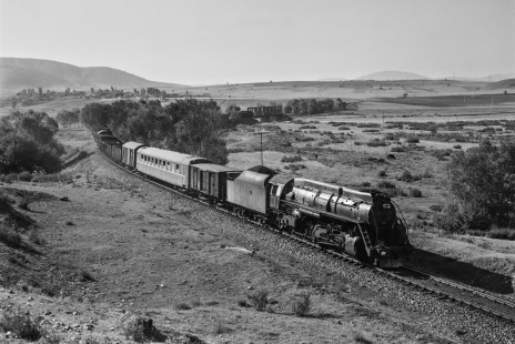 Turkish State Railways steam locomotive 56388 leads a freight train south on the Zonguldak Line near İsmetpaşa, Turkey, on September 8, 1973. Pusher locomotive 56332 is visible on the bridge in the distance. Photograph by Victor Hand, collection of the Center for Railroad Photography & Art, Hand-TCDD-25-023