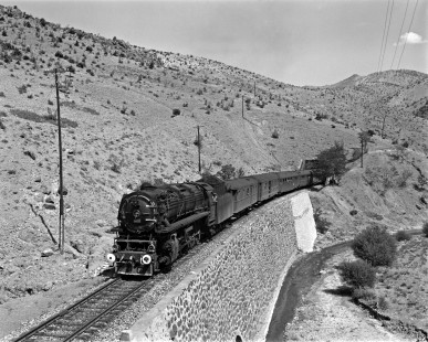 Turkish State Railways 56705, a 2-10-0 steam locomotive built in France, leads the Kurtalan to Ankara mail train west over a stone retaining wall near Çiftehan, Turkey, on September 15, 1973. Photograph by Victor Hand, Collection of the Center for Railroad Photography & Art, Hand-TCDD-25-156