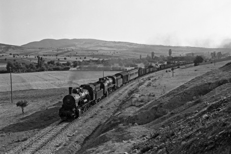 German-built steam locomotives 55048 (0-10-0) and 57002 (2-10-2) lead a Turkish State Railways freight train east on the Izmir-Afyon Line near Dumlupınar, Turkey, on September 16, 1973. Photograph by Victor Hand, Collection of the Center for Railroad Photography & Art, Hand-TCDD-25-184