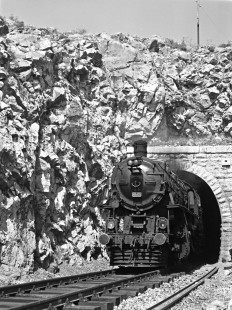 Turkish State Railways 45021, a Belgium-built 2-8-0 locomotive, steams out of a tunnel near Suluova, Turkey, with the morning passenger train from Samsun to Sivas on September 10, 1973. Photograph by Victor Hand, collection of the Center for Railroad Photography & Art, Hand-TCDD-25-045