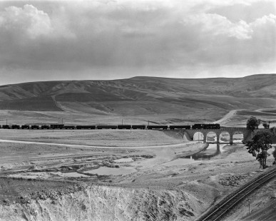 Turkish State Railways 56118, a Czech-built 2-10-0 steam locomotive, leads a freight train east over a viaduct on the Sivas-Malatya Line near Cetinkaya on September 11, 1973. Photograph by Victor Hand, collection of the Center for Railroad Photography & Art, Hand-TCDD-25-053