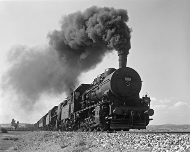 Two German-built steam locomotives lead a Turkish State Railways freight train east on the Izmir-Afyon Line near Uşak, Turkey, on September 16, 1973. The 55048 is an 0-10-0 built by Berliner Maschinenbau AG in 1924 and the 57002 is a 2-10-2 by Krupp in 1933. Photograph by Victor Hand, Collection of the Center for Railroad Photography & Art, Hand-TCDD-25-183