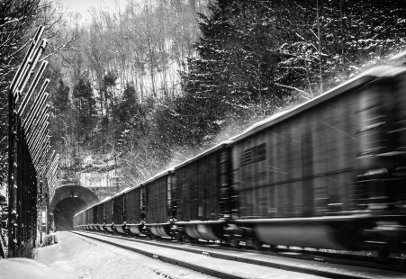 A train of loaded coal hoppers fly into Elkhorn Tunnel outside of Maybeury as they head east to Bluefield, WV over the Elkhorn Grade of the Norfolk & Western. January 28, 2021
