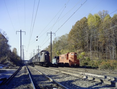 Two GG1 electric locomotives of Pennsylvania Railroad heritage lead Amtrak train 88, the <i>Silver Star</i> from Miami to New York, past a work train at Principio, Maryland, on November 4, 1979. Amtrak operations of GG1s ended the following year. Photograph by Victor Hand, collection of the Center for Railroad Photography & Art, Hand-AM-C59-50