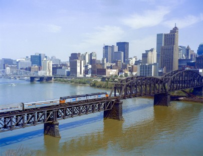 Amtrak's <i>National Limited</i> crosses the Monongahela River in Pittsburgh, Pennsylvania, on May 11, 1975. The train ran from 1971 until 1979 between Kansas City and New York/Washington. Today only trains of the Pittsburgh Light Rail use this bridge. Photograph by Victor Hand, collection of the Center for Railroad Photography & Art, Hand-AM-C59-10