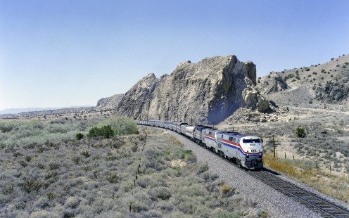 Amtrak's <i>Southwest Chief</i> rolls east through the rocky desert landscape of northern New Mexico near the ghost town of Waldo on May 6, 1996. Two General Electric P40 "Genesis" locomotives lead the train. Introduced in 1992, GE's Genesis series became the face of Amtrak for nearly three decades. Photograph by Victor Hand, collection of the Center for Railroad Photography & Art, Hand-AM-C59-113