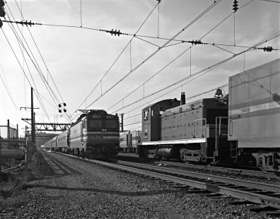 AEM-7 electric locomotive 937 leads <i>Metroliner</i> train 108 north for New York City out of Washington, D.C.'s Union Station on November 15, 1989, while SW1 738 shuffles cars on the adjacent track. Photograph by Victor Hand, collection of the Center for Railroad Photography & Art, Hand-AM-59-514