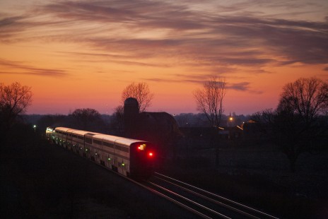 Amtrak's <i>Empire Builder</i> rolls off into a colorful Midwestern sunset near Columbus, Wisconsin, on the afternoon of December 18, 2011. Photograph by Scott Lothes, president and executive director of the Center for Railroad Photography & Art