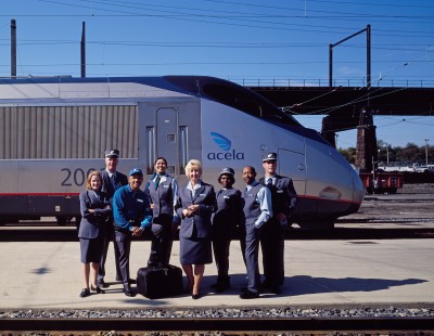 Amtrak employees show off their new uniforms in front of the brand-new <i>Acela</i> train at Union Station in Washington, D.C., in 2000. Photograph by Carol M. Highsmith, collection of the Library of Congress