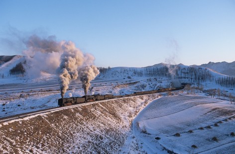 Jitong Railway QJ-class steam locomotive nos. 7112 and 6763 lead freight train through Tunnel no. 4 west of Shangdian, Inner Mongolia, China, on November 29, 2003. Photograph by Katherine Botkin. BOTKINK-103-KT-192