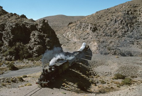 Ferrocarriles Argentinos (Argentine Railways) steam locomotive no. 6 leads southbound mixed train south of Cerro La Mesa, a mountain in the Cordillera de la Ramada range of the Andes, in Argentina, on March 22, 1996. Photograph by Katherine Botkin. BOTKINK-100-KT-39, © 1996, Katherine Botkin