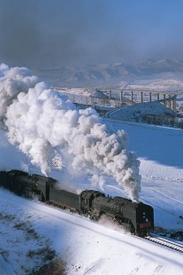 Two Jitong Railway QJ-class steam locomotives lead eastbound train west of Hadashan, Inner Mongolia, China, on November 26, 2003. Photograph by Katherine Botkin. BOTKINK-103-KT-176, © 2003, Katherine Botkin