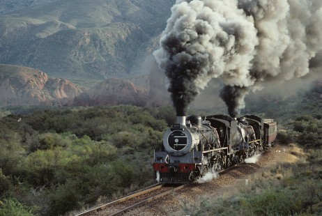 South African Railways 24-class steam locomotive nos. 3683 and 3684 lead northbound train at Barandas, Cape Province (present-day Western Cape), South Africa, on July 24, 1990. Photograph by Katherine Botkin. BOTKINK-113-KT-297, © 1990, Katherine Botkin.