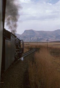 South African Railways 25NC-class steam locomotive no. 3408 with southbound train no. 55548  en route between Fouriesburg, and Ficksburg, in Orange Free State (present-day Free State), South Africa, on May 29, 1985. Photograph by Katherine Botkin. BOTKINK-113-KT-81 © 1985, Katherine Botkin.