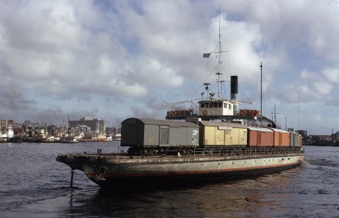The classic Scottish-built steel screw steam train ferry, the <i>Mercedes Lacroze</i>, clears away from South Dock in Buenos Aires, Argentina, on July 6, 1973. A. & J. Inglis Ltd. built the vessel in 1909 by on behalf of the original owner, the British-owned standard gauge Entre Rios Railway. 

Judges' comments: These three rail ferry images immediately captivated the judges for their evocative composition and Kodachrome color vitality. They magically transport the viewer on an exotic visual journey that parallels that of the railcar’s physical transfer from land to water. Each image offers a portal to an earlier age, rendered in soft colors and compositions that evoke movement.

Read more about the 2021 John E. Gruber Creative Awards Program: <a href="https://railphoto-art.org/awards/2021-awards/" rel="noreferrer nofollow">railphoto-art.org/awards/2021-awards/</a>