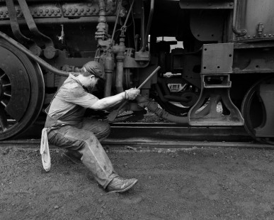 Strasburg Rail Road hostler Ross Gochenaur closes the ashpan door of ex-Norfolk & Western Railway 4-8-0 steam locomotive 475 at East Strasburg, Pennsylvania, on August 12, 2017.

Judges' comments: This series’ strong composition and tonality impressed the judges. Each image carefully calibrates foreground framing with storytelling of a fireman going about the time-honored tradition of preparing an iron horse for duty. The way the photographer follows the fireman’s movement and form are particularly poetic. 

Read more about the 2021 John E. Gruber Creative Awards Program: <a href="https://railphoto-art.org/awards/2021-awards/" rel="noreferrer nofollow">railphoto-art.org/awards/2021-awards/</a>