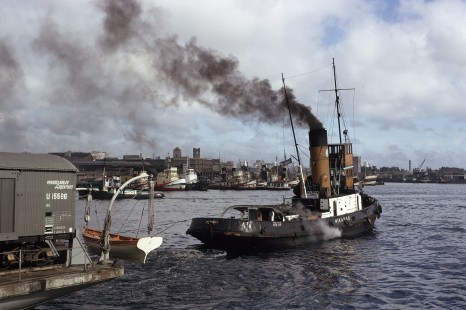 The classic steam tug <i>Mirador</i> (“Lookout”) assists the train ferry’s departure from South Dock in Buenos Aires, Argentina, on July 6, 1973.

Judges' comments: These three rail ferry images immediately captivated the judges for their evocative composition and Kodachrome color vitality. They magically transport the viewer on an exotic visual journey that parallels that of the railcar’s physical transfer from land to water. Each image offers a portal to an earlier age, rendered in soft colors and compositions that evoke movement.

Read more about the 2021 John E. Gruber Creative Awards Program: <a href="https://railphoto-art.org/awards/2021-awards/" rel="noreferrer nofollow">railphoto-art.org/awards/2021-awards/</a>