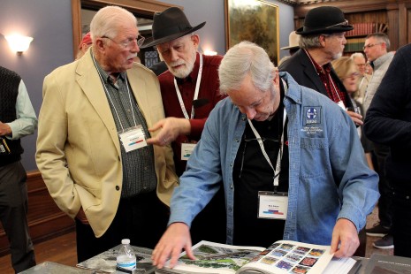 From left: Joe McMillan, Dennis Livesey, and Bob Alkire inspect the Center's newest book, Continuity and Change: The Lure of North American Railroads during Friday's reception. Erin Rose photo. Learn about the book here: <a href="https://railphoto-art.org/continuity-change/" rel="noreferrer nofollow">railphoto-art.org/continuity-change/</a>
