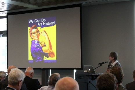 Board member Betsy Fahlman discusses railroad artwork during Saturday's presentations. ER photo.