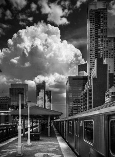 A thunderstorm looms in the distance from Queensboro Plaza Station in New York City, New York, on June 29, 2019.

Judges’ Comments: The judges debated whether clouds were a “weather effect” but this image’s surreal composition left no doubt that it met the criteria. The combination of strong, sharp angular building lines set against the soft white, explosive thunderhead beyond, produces a powerful visual tension, yielding a discordant depiction of summer heat becoming a storm in the city.

Read more about the 2022 John E. Gruber Creative Photography Awards: <a href="https://railphoto-art.org/awards-2022/" rel="noreferrer nofollow">railphoto-art.org/awards-2022/</a>