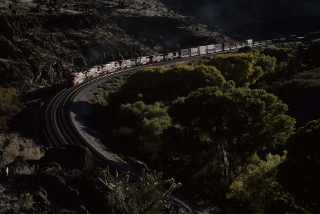 Atchison, Topeka and Santa Fe Railway diesel locomotive no. 833 leads eastbound freight train at Crozier Canyon, west of Truxton, Arizona, on November 6, 1994. Photograph by William Botkin, BOTKINW-15-WT-397 © 1994, William Botkin.