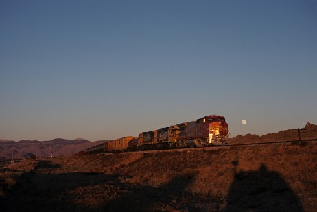 Atchison, Topeka and Santa Fe Railway diesel locomotive no. 538 leads westbound freight train near Walapi, Arizona, on December 1, 1990. The moon is visible near the horizon. Photograph by William Botkin, BOTKINW-15-WT-309 © 1990, William Botkin.