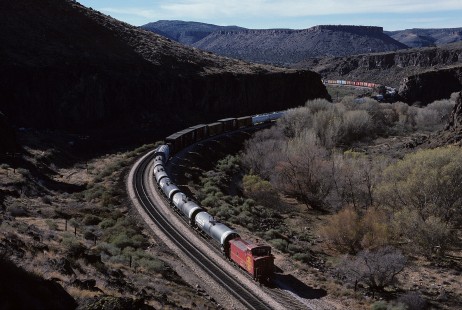 A GA-class caboose brings up the rear of westbound Atchison, Topeka and Santa Fe Railway freight train no. 408 at Crozier Canyon, west of Truxton, Arizona, on December 13, 1986. Photograph by William Botkin, BOTKINW-15-WT-261 © 1986, William Botkin.