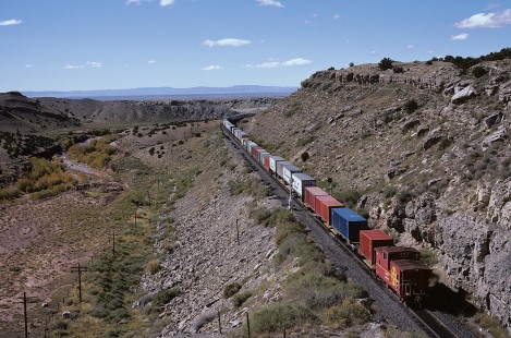 A GA-Class caboose brings up the rear of a westbound Atchison, Topeka and Santa Fe Railway freight train at Abo Canyon, east of Sais, New Mexico, on October 11, 1985. Photograph by William Botkin, BOTKINW-15-WT-183 © 1985, William Botkin.