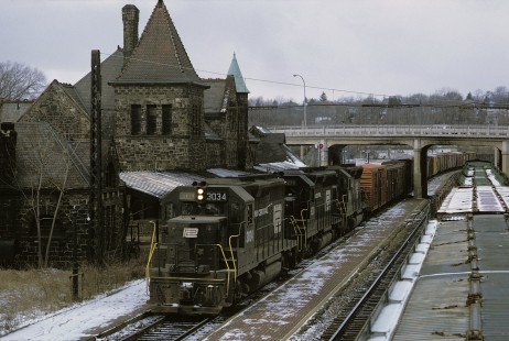 Penn Central GP-40 3034 leads two SD-45's on eastbound NY-4 through Ann Arbor, Michigan on a dreary day in January 1969.  NY-4 carries both reefers and stock cars in its consist. Photograph by William Botkin, BOTKINW-10-WT-224 © 1969, William Botkin.