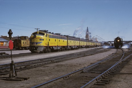 Union Pacific Railroad locomotive no. 944 leads westbound combined "City of Los Angeles," "City of San Francisco," and "Challenger" passenger train next to locomotive no. 8444 leading a passenger train at Cheyenne, Wyoming, on March 26, 1971. Photograph by William Botkin, BOTKINW-19-WT-37 © 1971, William Botkin.