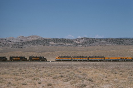 Denver and Rio Grande Western Railroad locomotive no. 5771-led Rio Grande Zephyr no. 18 meets westbound freight at Cliff, Utah, on July 28, 1974. Photograph by William Botkin, BOTKINW-8-WT-133 © 1974, William Botkin.