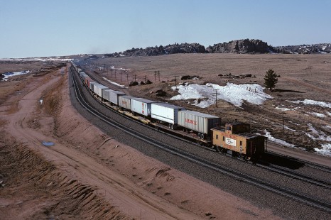 Union Pacific Railroad locomotive no. 3650 leads westbound freight train 020MN with GA caboose at Dale Junction, Wyoming, at 2:35 pm on March 14, 1985. Photograph by William Botkin, BOTKINW-19-WT-384 © 1985, William Botkin.