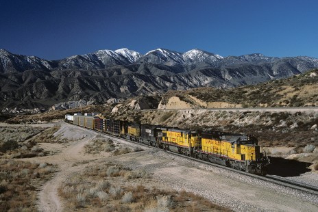 Union Pacific Railroad locomotive no. 3704 hauls eastbound freight at Cajon Pass, west of Summit, California, at 9:16 am, on December 11, 1986. Photograph by William Botkin, BOTKINW-19-WT-449 © 1986, William Botkin.