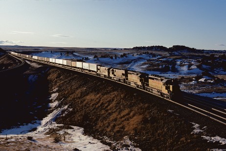 Union Pacific Railroad locomotive no. 3483 leads eastbound piggyback freight train 2FTX at Dale Junction, Wyoming, at 3:50 pm on December 7, 1984. Photograph by William Botkin, BOTKINW-19-WT-371 © 1984, William Botkin.