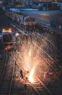 Thermite welding is the most common method of bonding rail lengths in railway construction, as displayed at a rail yard in Burnie, Tasmania, on May 21, 2022.

Judges’ Comments: A thermite welder in action presents a fountain of hot metal fragments that cascades across this beautifully composed scene of railroad track maintenance. Captured through a telephoto lens, this image poetically depicts both contemporary rail welding technology and digital photography capability at night.

Read more about the 2023 John E. Gruber Creative Photography Awards: <a href="https://railphoto-art.org/awards-2023/" rel="noreferrer nofollow">railphoto-art.org/awards-2023/</a>
