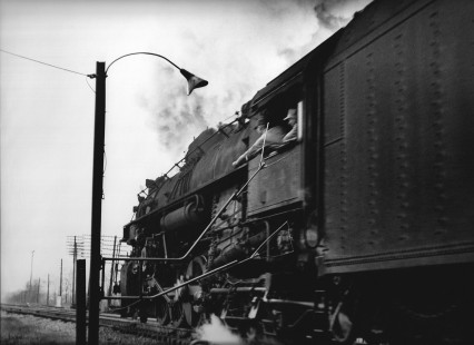 With Nickel Plate 2-8-4 no. 744 running over fifty miles per hour, the head brakeman expertly captures orders from the dispatcher on the fly at Painesville, Ohio, on November 29, 1957.  

Judges’ Comments: The power and energy of a Nickel Plate Road Berkshire at speed sweeps past a train order stand as the crew catches orders on the fly. While a common scene for much of railroading of the first half of the twentieth century, this image beautifully conveys the split-second moment of transfer with an inherent sense of movement and energy as the train rushes onward. This photograph serves as a compelling testament to the evolution of technology and the expertise involved in its artistic portrayal. This image was created in the steam age long before digital camera technology, making it all the more impressive.

Read more about the 2023 John E. Gruber Creative Photography Awards: <a href="https://railphoto-art.org/awards-2023/" rel="noreferrer nofollow">railphoto-art.org/awards-2023/</a>