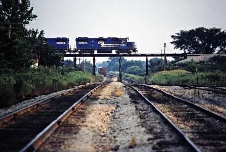 Conrail locomotives lead a westbound Missouri–Kansas–Texas Railroad freight train across the Kansas City Southern Railway in Eve, Missouri, on July 13, 1981. Photograph by John F. Bjorklund, © 2016, Center for Railroad Photography and Art. Bjorklund-70-07-10