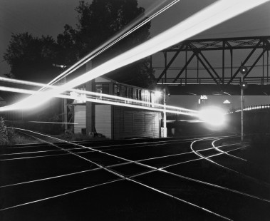 Raleigh's Boylan Avenue tower is illuminated first by the curved path of Seaboard Air Line' s Florida-bound <i>Silver Star</i> passenger train and a few minutes later by a southbound Norfolk Southern Railway local heading to nearby Fayetteville, North Carolina, on an August night in 1961. Photograph by J. Parker Lamb, © 2016, Center for Railroad Photography and Art. Lamb-01-068-07
