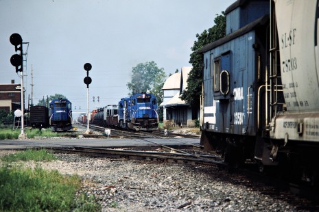 Eastbound Conrail freight train (center) in Muncie, Indiana, with freight house (left), passenger station (right), and curving NS track to Cincinnati on August 11, 1984. Photograph by John F. Bjorklund, © 2015, Center for Railroad Photography and Art. Bjorklund-29-11-16