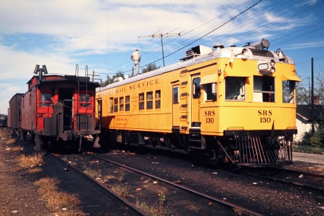 Clinchfield Railroad caboose next to a Sperry Rail Service car in Spartanburg, South Carolina, on October 18, 1972. Photograph by John F. Bjorklund, © 2015, Center for Railroad Photography and Art. Bjorklund-41-16-18