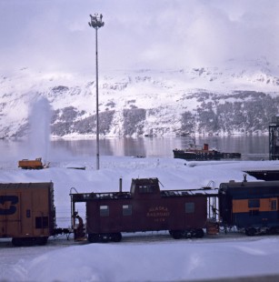 Snow plow and tug boat behind Alaska Railroad freight train at Whittier, c. 1973. Photograph by Leo King, © 2015, Center for Railroad Photography and Art. King-02-029-012